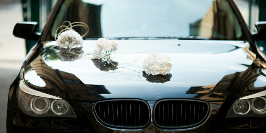 black-bmw-decorated-with-white-wedding-bouquets